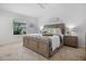 Spacious bedroom with a neutral color palette, ceiling fan, and natural light from the window at 6231 Atkinson Ln, The Villages, FL 32163