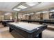 Well-lit billiard room with pool tables and comfortable seating for leisure activities at 6231 Atkinson Ln, The Villages, FL 32163