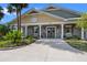 Community clubhouse with a welcoming entrance, landscaped surroundings, and architectural details at 6231 Atkinson Ln, The Villages, FL 32163