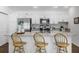 Bright kitchen features a large island, bar seating, stainless steel appliances, and modern finishes at 6231 Atkinson Ln, The Villages, FL 32163