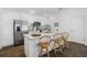 Bright kitchen with stainless steel appliances, granite counters, and a breakfast bar with chairs at 6231 Atkinson Ln, The Villages, FL 32163