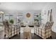 Cozy living room featuring stylish chairs, a comfortable sofa, and bright natural light at 6231 Atkinson Ln, The Villages, FL 32163