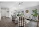 Bright open-concept space with a dining area, stylish seating, and dark laminate floors at 6231 Atkinson Ln, The Villages, FL 32163