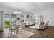 Bright open-concept space with a dining area, stylish seating, and lovely backyard views at 6231 Atkinson Ln, The Villages, FL 32163