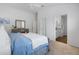 Bright main bedroom featuring neutral walls, ensuite bathroom, ceiling fan, and a comfy queen size bed at 6231 Atkinson Ln, The Villages, FL 32163