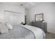 Bright main bedroom featuring a ceiling fan, ensuite bathroom, and closet at 6231 Atkinson Ln, The Villages, FL 32163