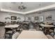 Large meeting room features tables, chairs, decorative lighting, and patterned wallpaper at 6231 Atkinson Ln, The Villages, FL 32163