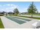 Features well-maintained shuffleboard courts and community space with lush greenery at 6231 Atkinson Ln, The Villages, FL 32163