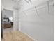 Spacious walk-in closet with wire shelving and a view into the bedroom at 6231 Atkinson Ln, The Villages, FL 32163