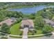 Aerial view of house and lush green landscaping next to a serene lake at 1017 Parkside Pointe Blvd, Apopka, FL 32712
