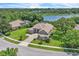 Aerial view of home showcasing the surrounding lush landscaping with a lake view at 1017 Parkside Pointe Blvd, Apopka, FL 32712