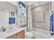 Cozy bathroom featuring updated vanity, shower-tub combo with tile surround, and decorative blue accents at 1017 Parkside Pointe Blvd, Apopka, FL 32712