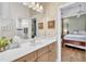 Charming bathroom with floral wallpaper, bright vanity, and doorway view to the bedroom at 1017 Parkside Pointe Blvd, Apopka, FL 32712