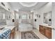 Bright bathroom featuring dual sinks, a soaking tub, and decorative accents at 1017 Parkside Pointe Blvd, Apopka, FL 32712