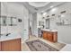 Bathroom featuring dual sinks, large mirrors, and an decorative rug at 1017 Parkside Pointe Blvd, Apopka, FL 32712
