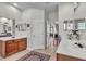 Bright bathroom featuring double sinks, wood cabinets, a neutral color palette, and tile flooring throughout at 1017 Parkside Pointe Blvd, Apopka, FL 32712
