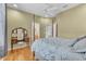 Comfortable bedroom featuring light-colored walls, hardwood floors, and a stylish vanity at 1017 Parkside Pointe Blvd, Apopka, FL 32712