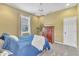 Neutral bedroom featuring cozy queen bed, plush carpet, bright window, ceiling fan and tasteful decor at 1017 Parkside Pointe Blvd, Apopka, FL 32712