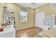 Cozy bedroom featuring a ceiling fan, bright window, closet and dresser with plenty of storage space at 1017 Parkside Pointe Blvd, Apopka, FL 32712
