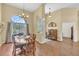 The dining area is bright, with beautiful hardwood flooring, a large arch window, and charming furniture at 1017 Parkside Pointe Blvd, Apopka, FL 32712