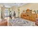 Inviting foyer features hardwood floors, an area rug, with a large cabinet for storage at 1017 Parkside Pointe Blvd, Apopka, FL 32712