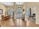 Bright foyer featuring a double door entrance, high ceilings, wood floors, and views into the dining and office spaces at 1017 Parkside Pointe Blvd, Apopka, FL 32712