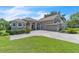 Lovely landscaped home with a paver driveway, arched entryway, and attached two-car garage at 1017 Parkside Pointe Blvd, Apopka, FL 32712