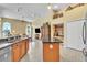 Open kitchen with a large island, stainless appliances, and views to the living room at 1017 Parkside Pointe Blvd, Apopka, FL 32712