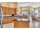 Open kitchen featuring stainless steel appliances, an island, and views to the Gathering room and outdoor pool at 1017 Parkside Pointe Blvd, Apopka, FL 32712
