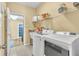 Functional laundry room with modern washer and dryer, utility sink, and ample storage at 1017 Parkside Pointe Blvd, Apopka, FL 32712