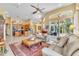 Inviting living room with tile floors, a ceiling fan, access to the lanai, and an open-concept design at 1017 Parkside Pointe Blvd, Apopka, FL 32712