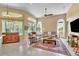 Spacious living room featuring tile floors, large windows, and comfortable seating at 1017 Parkside Pointe Blvd, Apopka, FL 32712