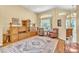 Cozy living room features a patterned rug, hardwood floors, and plenty of natural light at 1017 Parkside Pointe Blvd, Apopka, FL 32712