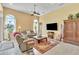 Comfortable living room with natural lighting, ceiling fan, neutral colored furniture, and tile floors at 1017 Parkside Pointe Blvd, Apopka, FL 32712