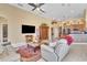 Open living room with tile flooring, a ceiling fan, and views of the kitchen and dining area at 1017 Parkside Pointe Blvd, Apopka, FL 32712