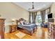 Spacious main bedroom with hardwood floors, elegant decor, and sliding door access to the patio at 1017 Parkside Pointe Blvd, Apopka, FL 32712