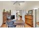 Bright home office with a ceiling fan, hardwood floors, and a lovely view out to the living room through double doors at 1017 Parkside Pointe Blvd, Apopka, FL 32712