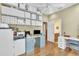 Office space featuring a white ceiling fan, hardwood floors, and generous storage shelves at 1017 Parkside Pointe Blvd, Apopka, FL 32712