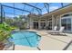 Relaxing screened-in pool with well manicured landscaping, perfect for relaxation at 1017 Parkside Pointe Blvd, Apopka, FL 32712