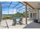 Relaxing screened-in pool area with a beautiful view, lounge chairs, and outdoor seating at 1017 Parkside Pointe Blvd, Apopka, FL 32712