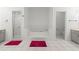 Bright bathroom featuring a soaking tub, separate shower, and tile flooring at 103 Odin Dr, Winter Haven, FL 33884