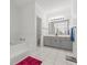 Bright bathroom featuring a tub and a vanity with gray cabinets at 103 Odin Dr, Winter Haven, FL 33884