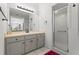 Bathroom featuring a glass shower, tub, and neutral cabinets at 103 Odin Dr, Winter Haven, FL 33884