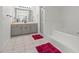 Bathroom featuring a tub, separate glass shower, neutral countertops, and tile flooring at 103 Odin Dr, Winter Haven, FL 33884