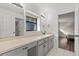 Bathroom with large vanity, gray cabinets, tile floors, and a separate water closet at 103 Odin Dr, Winter Haven, FL 33884