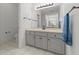 Bathroom vanity with gray cabinets, light countertop, and a large mirror at 103 Odin Dr, Winter Haven, FL 33884