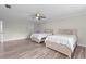 This bedroom features two twin beds, wood-look floors, and a ceiling fan at 103 Odin Dr, Winter Haven, FL 33884