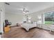 Bright bedroom featuring two beds, a ceiling fan, and hardwood flooring at 103 Odin Dr, Winter Haven, FL 33884