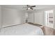Bedroom with two closets, ceiling fan, ensuite bathroom, and wood-look floors at 103 Odin Dr, Winter Haven, FL 33884