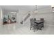Open concept dining room with modern chandelier and staircase view at 103 Odin Dr, Winter Haven, FL 33884